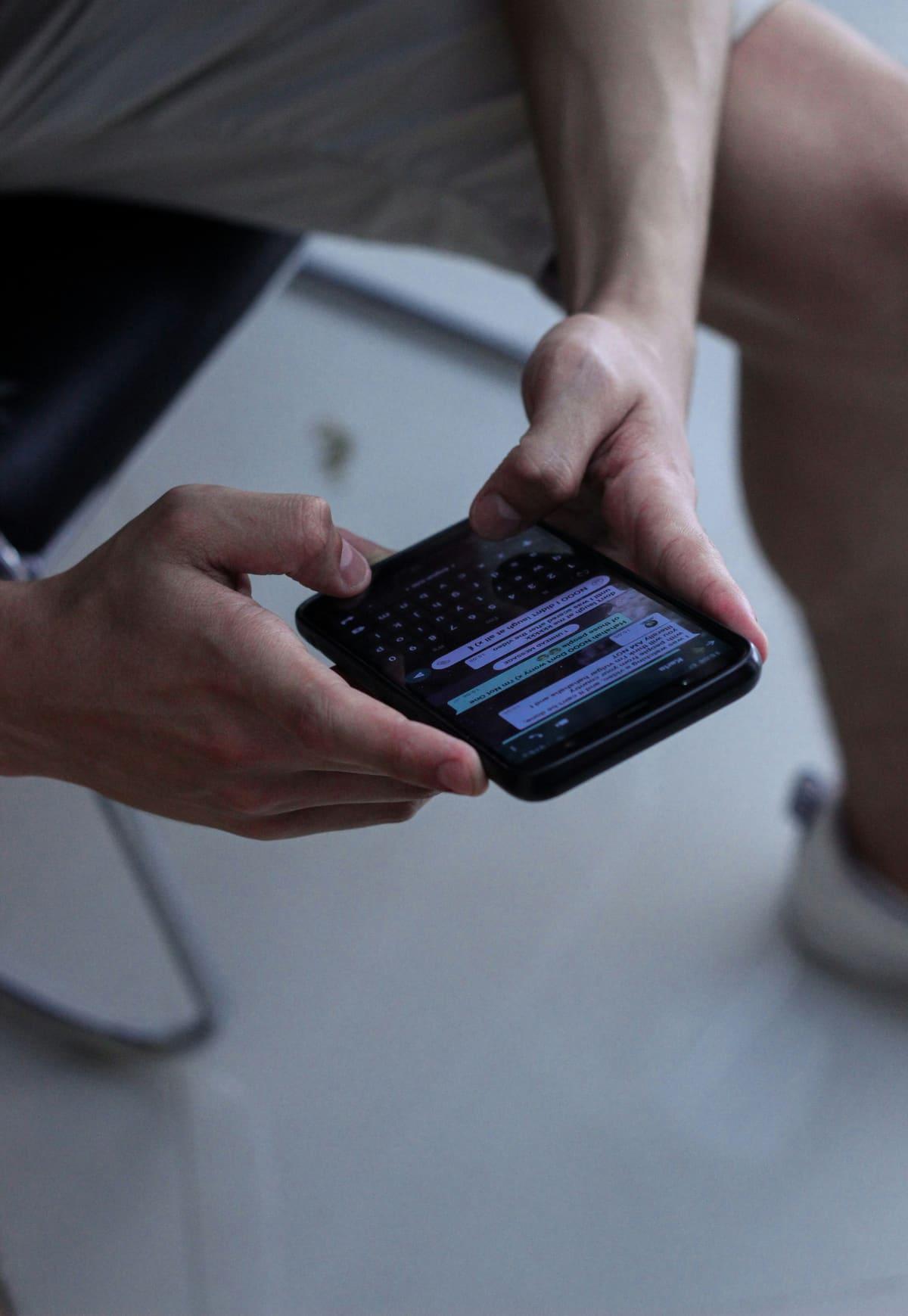 A person reading a WhatsApp message on their phone